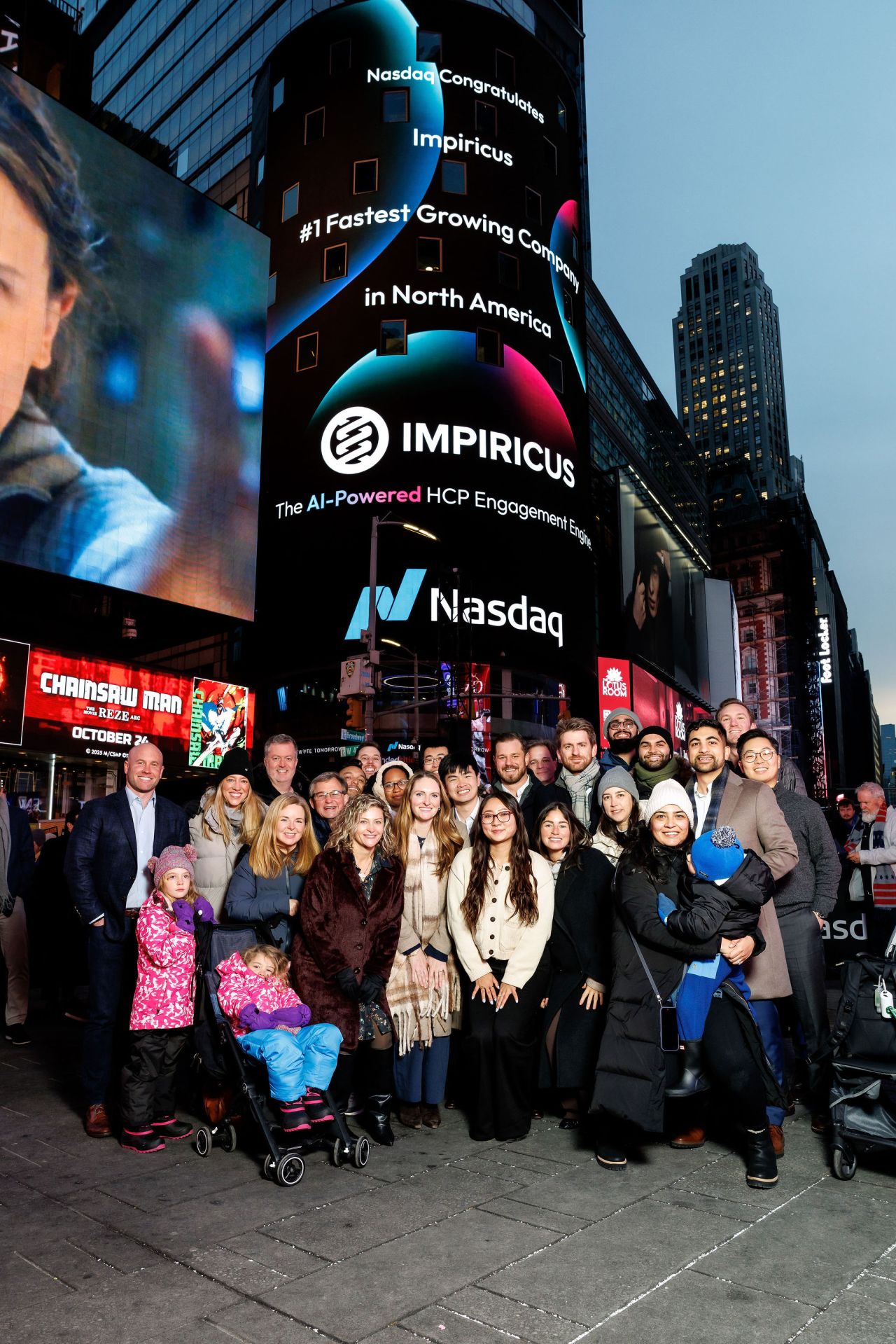 Impiricus team celebrating a Nasdaq Times Square billboard recognizing Impiricus as the #1 fastest-growing company in North America.